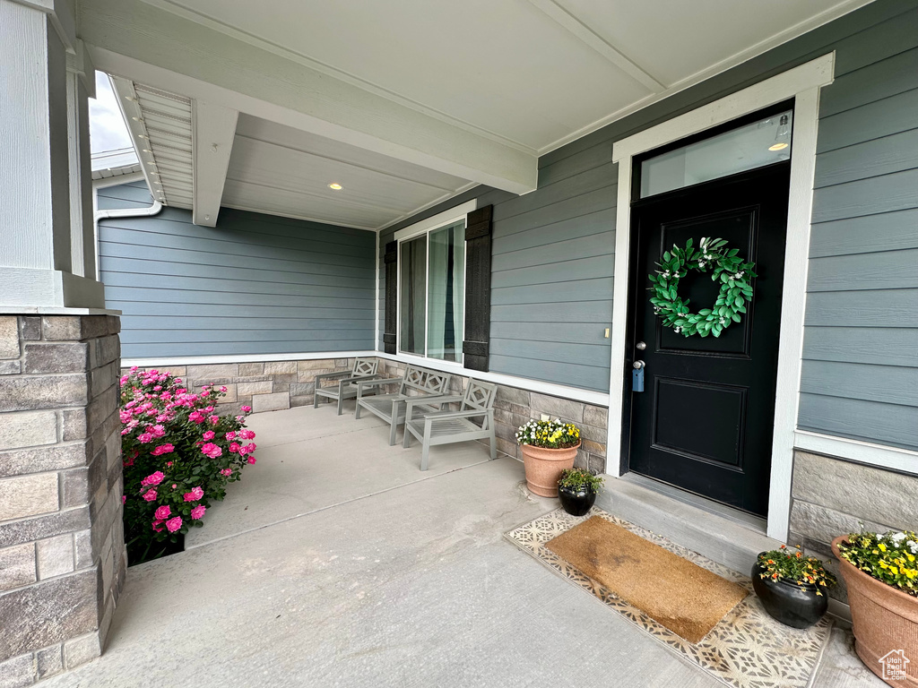 View of exterior entry with a porch