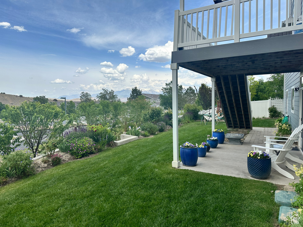 View of yard featuring stairway, a patio area, and a deck