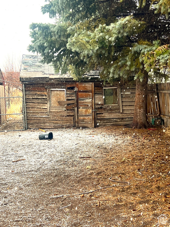 View of yard with an outdoor structure and fence