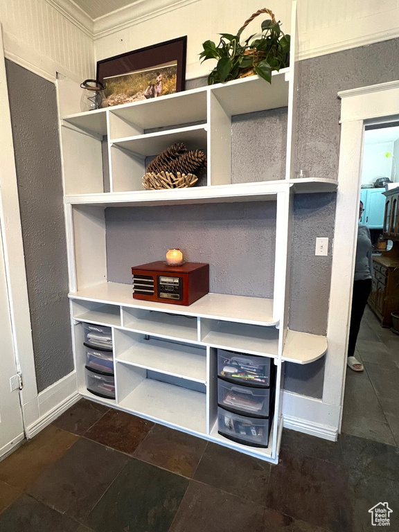 Details featuring crown molding and baseboards
