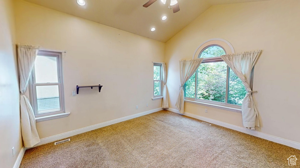 Empty room featuring ceiling fan, high vaulted ceiling, carpet flooring, and recessed lighting