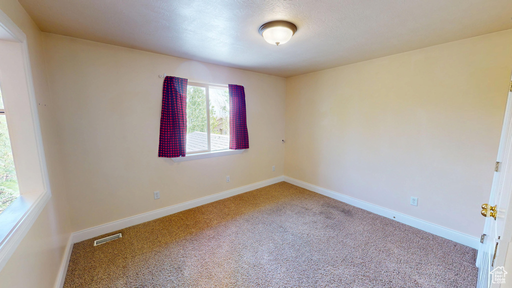 Unfurnished room featuring carpet flooring and baseboards