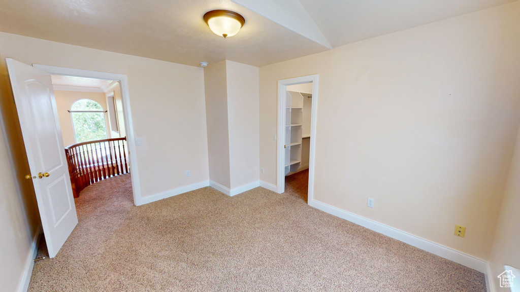 Unfurnished room with light colored carpet and baseboards