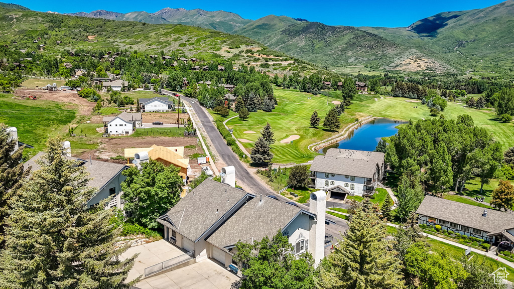 Aerial perspective of suburban area with a water and mountain view and a golf club