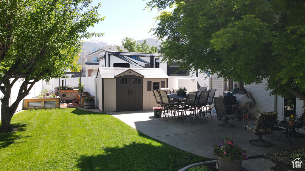 View of yard with a patio area and a vegetable garden