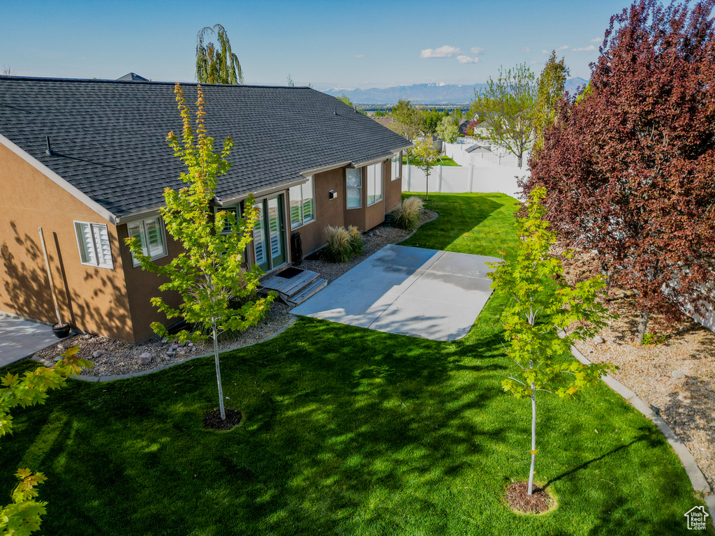 Back of property with french doors, a patio area, fence, a yard, and stucco siding