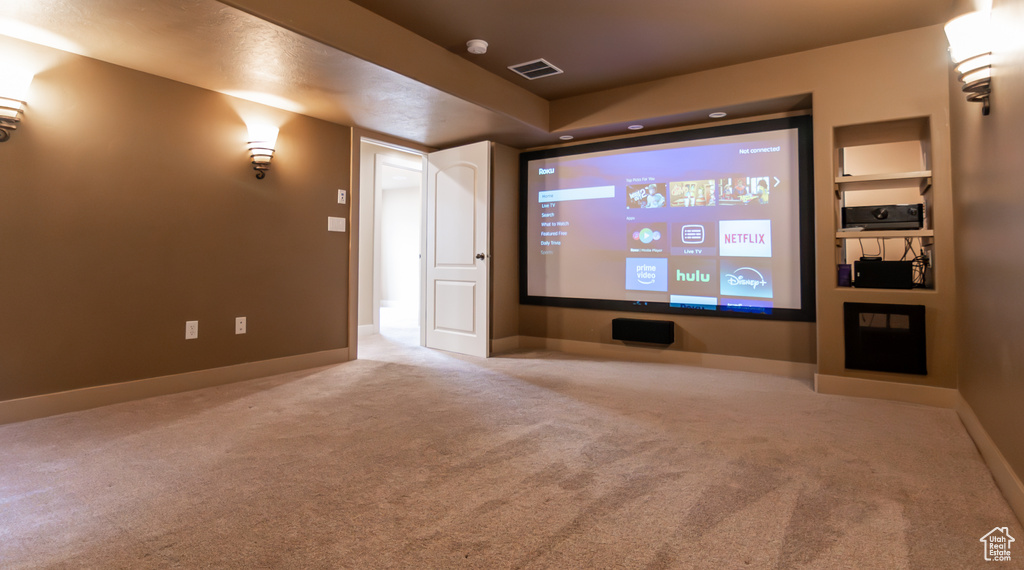 Carpeted home theater featuring baseboards and visible vents