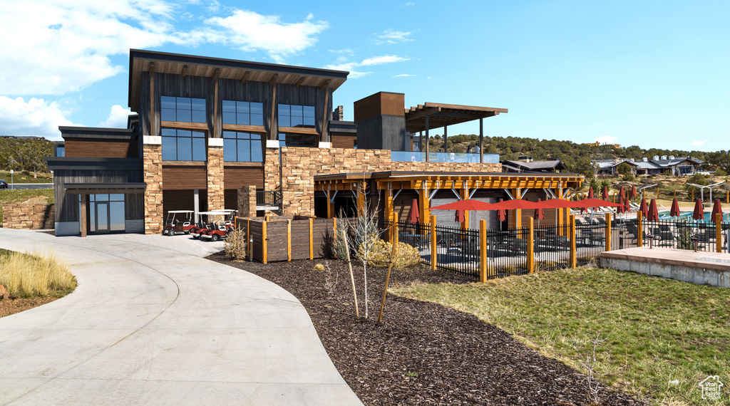 Exterior space featuring fence and stone siding