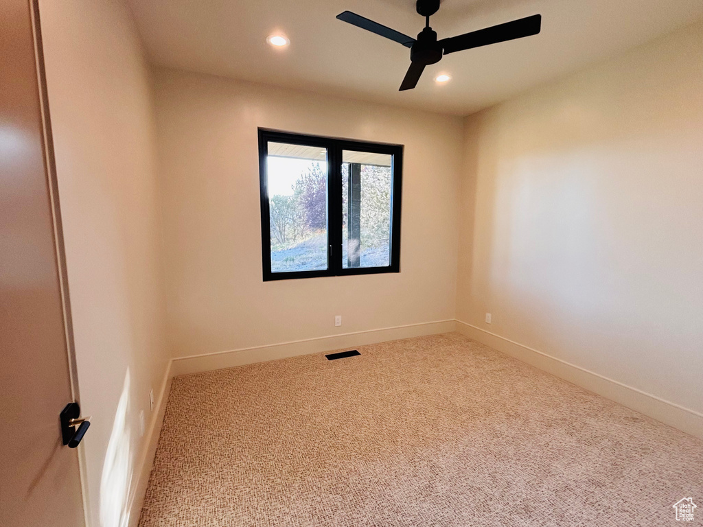 Spare room featuring carpet, ceiling fan, and recessed lighting