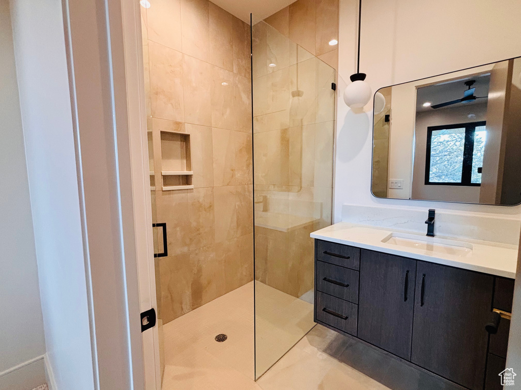 Full bathroom featuring tiled shower and vanity