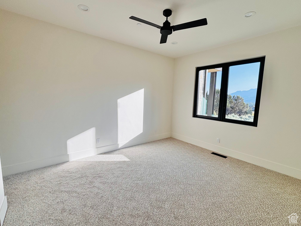 Spare room with light colored carpet, a ceiling fan, and recessed lighting