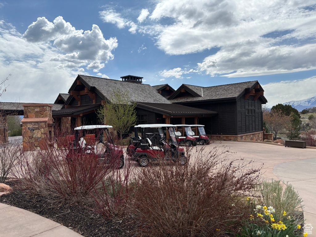View of front of property with concrete driveway and stone siding