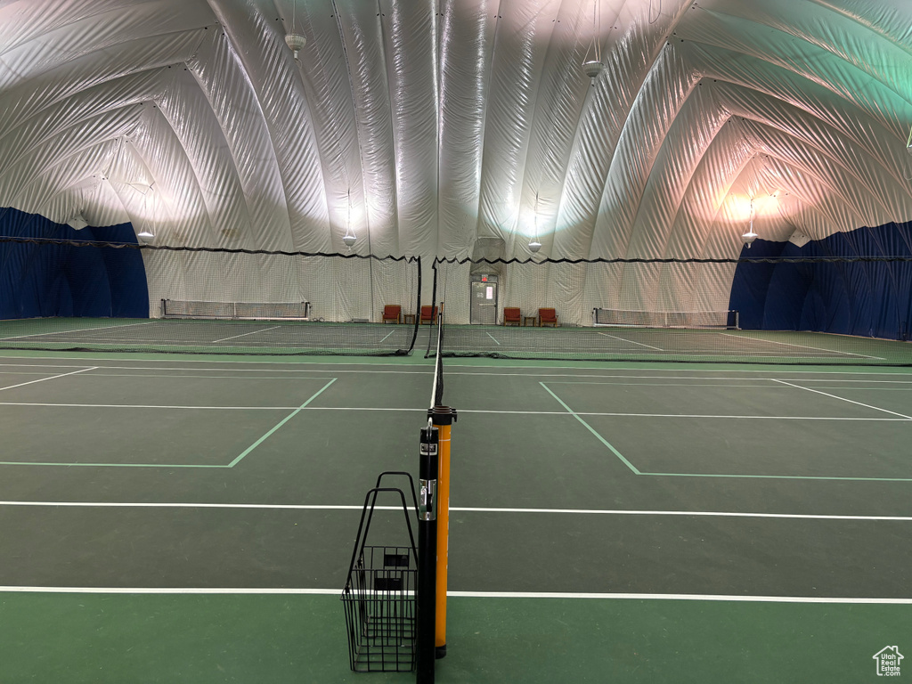 View of tennis court featuring fence