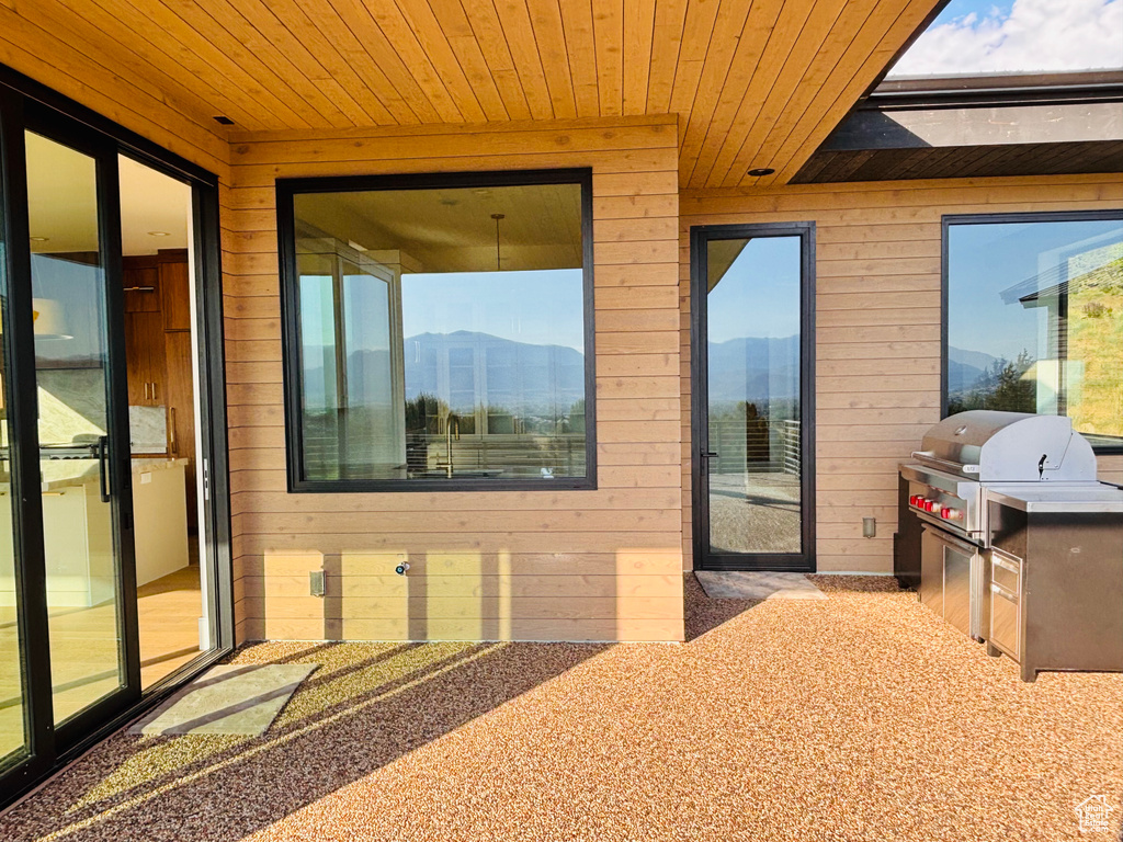 View of patio / terrace with an outdoor kitchen and a mountain view