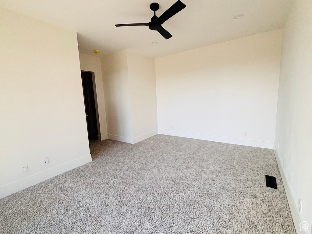 Unfurnished room with ceiling fan and carpet flooring