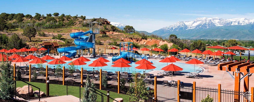 View of swimming pool featuring fence and a mountain view