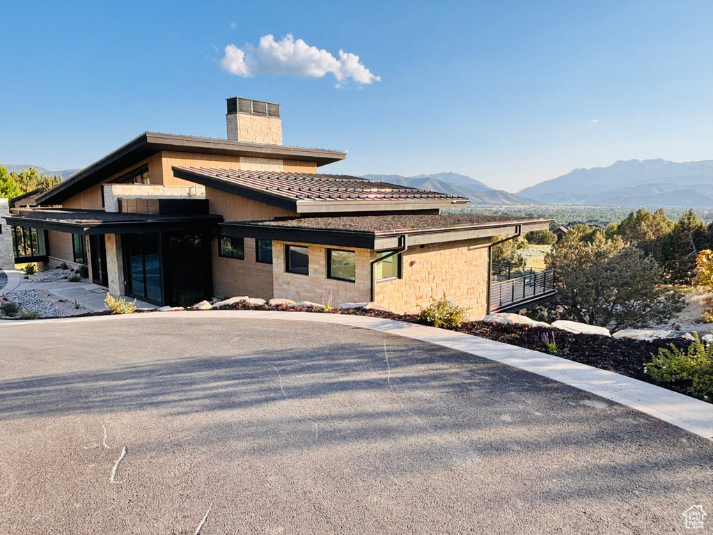 View of front of property featuring a chimney and a mountain view