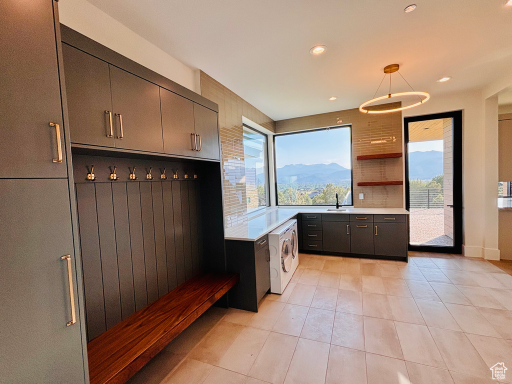 Mudroom with washer and clothes dryer, light tile patterned flooring, and recessed lighting