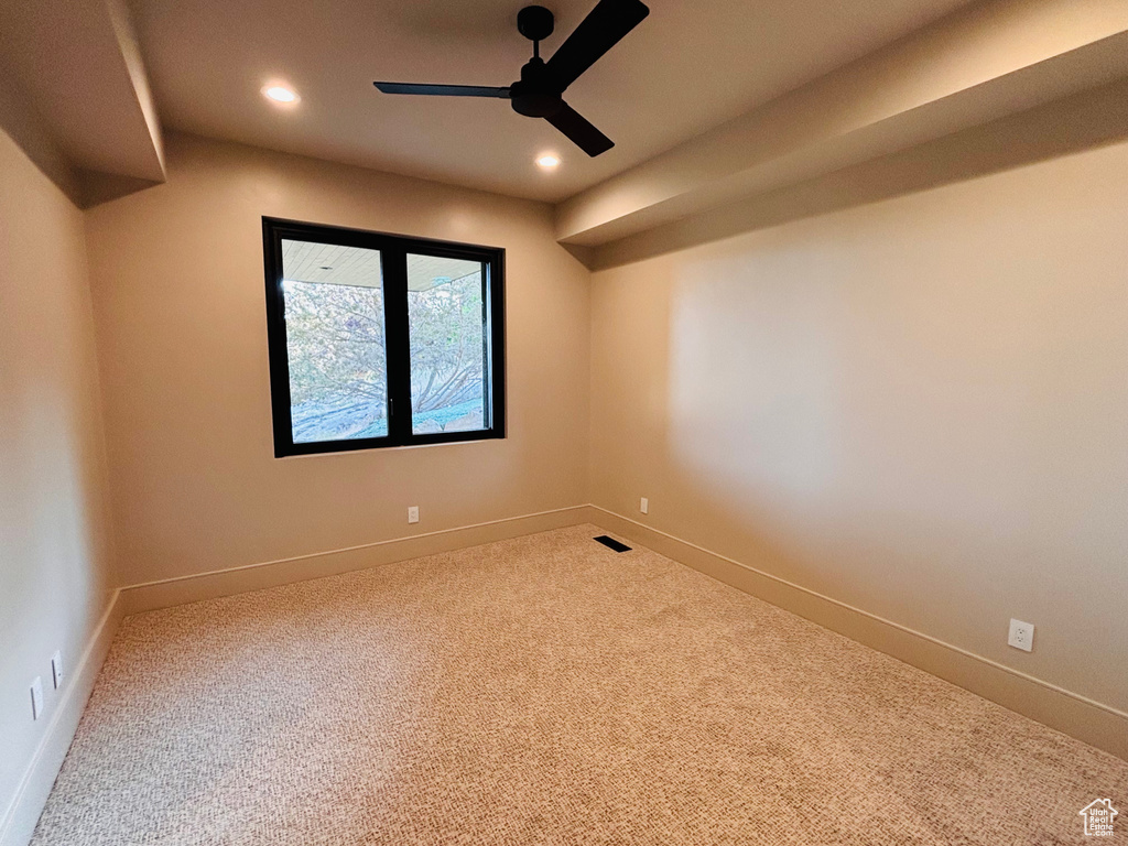 Spare room featuring carpet floors, recessed lighting, and a ceiling fan