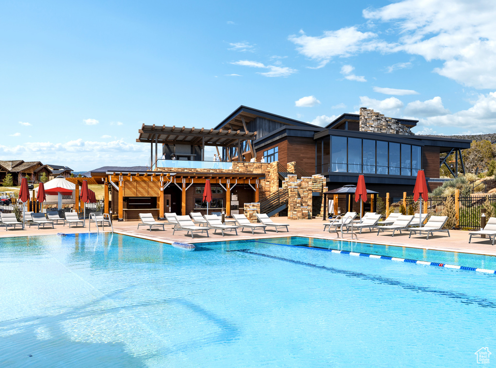 Pool featuring fence, a pergola, stairs, and a patio area
