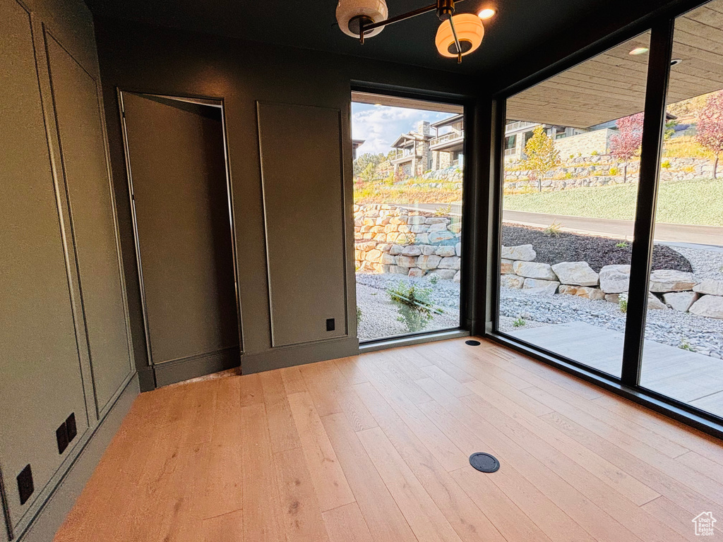 Spare room featuring healthy amount of natural light and light wood-style flooring