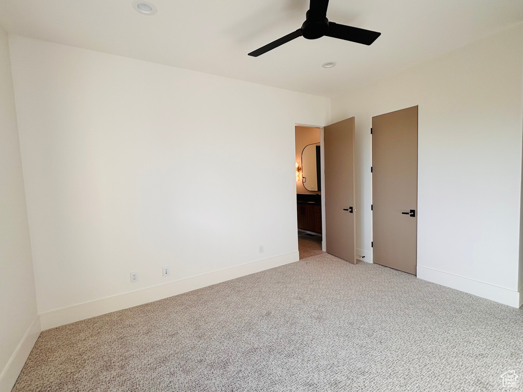 Spare room with light colored carpet, ceiling fan, and recessed lighting