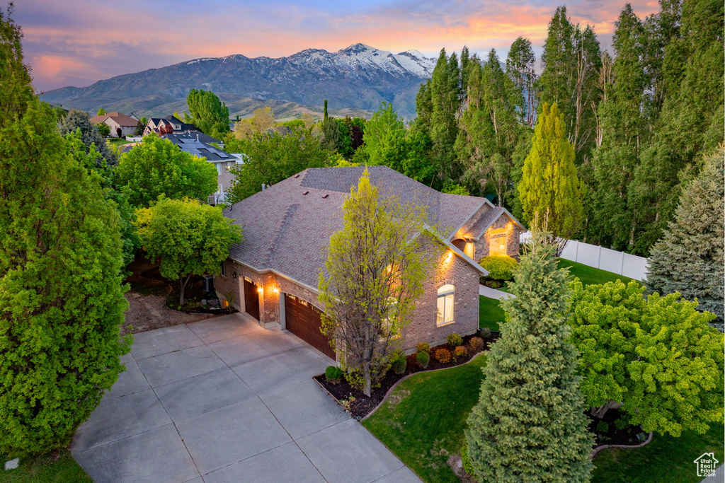 Aerial view of property and surrounding area with a mountain backdrop