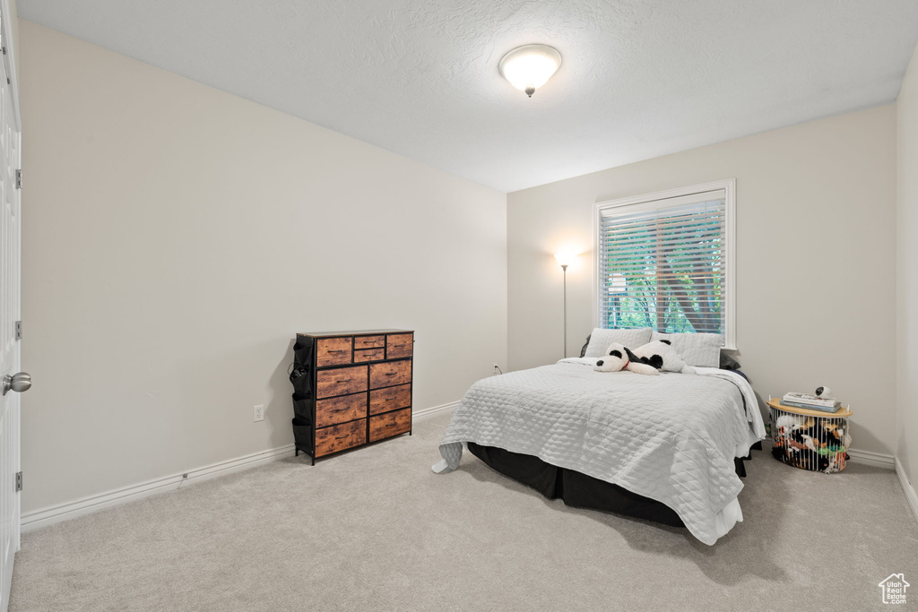 Carpeted bedroom with baseboards