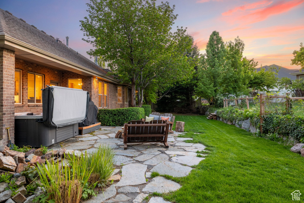 View of yard with a hot tub, an outdoor hangout area, and a patio