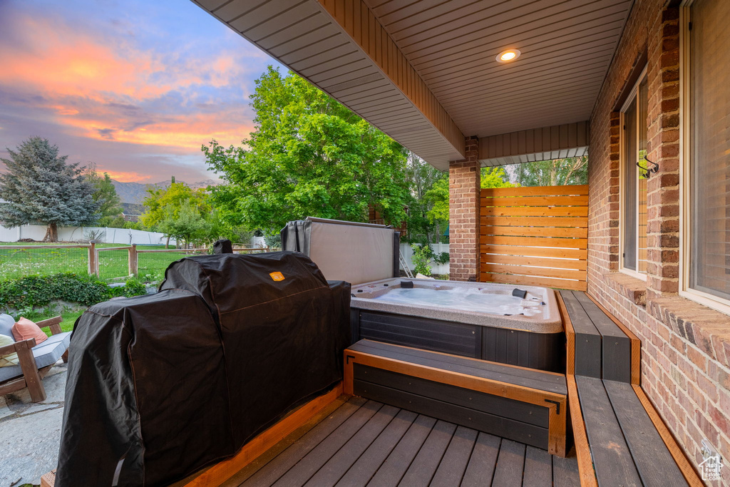 Wooden terrace featuring a hot tub