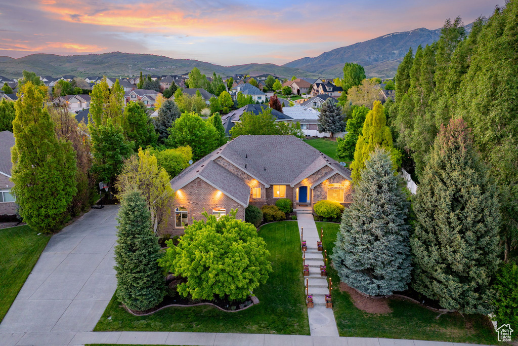 Aerial view of property and surrounding area featuring a mountain backdrop