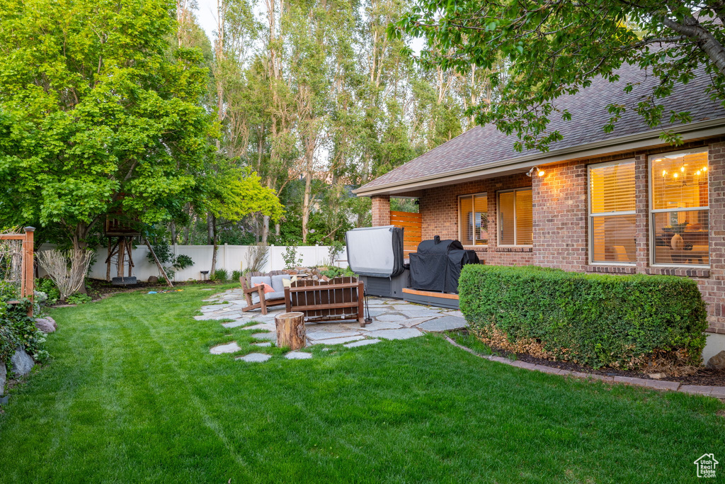 View of yard with outdoor lounge area and a patio