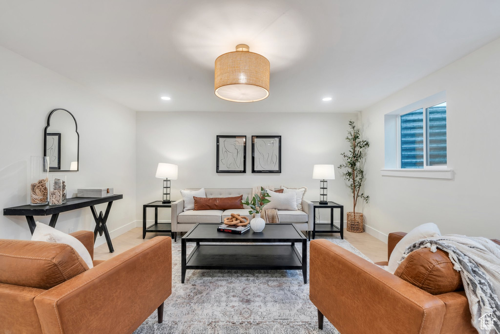 Living room featuring baseboards, light wood finished floors, and recessed lighting