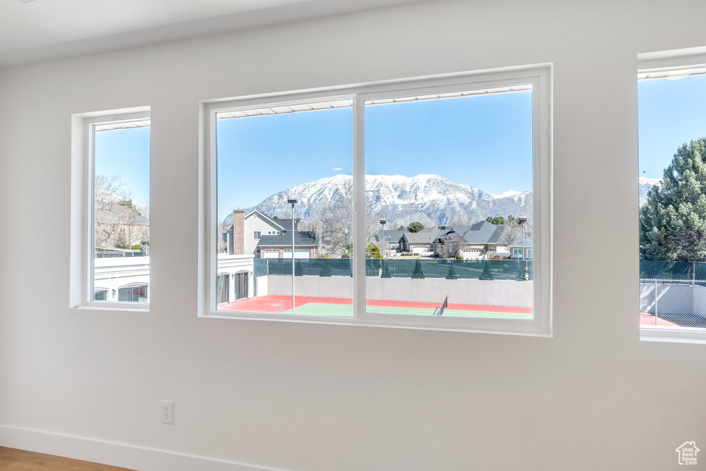 Room details with baseboards and a mountain view