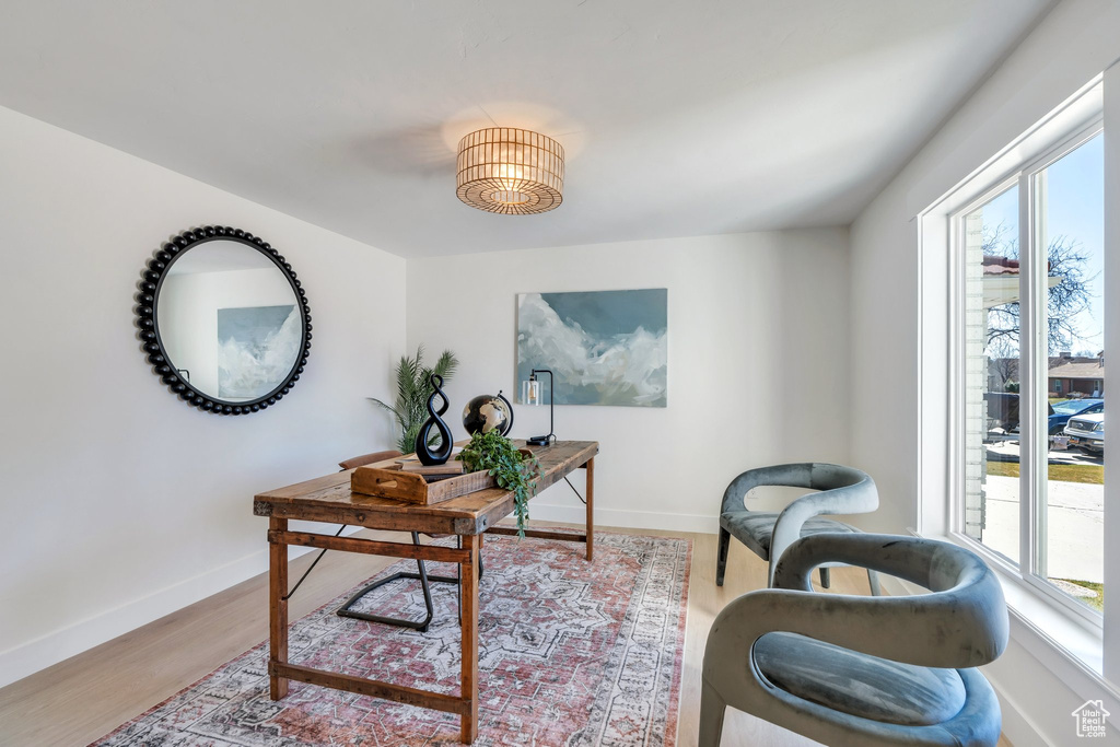 Office space with baseboards and wood finished floors