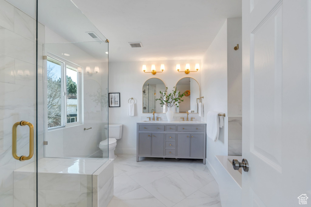 Full bathroom with marble finish floor, a sink, a stall shower, visible vents, and double vanity