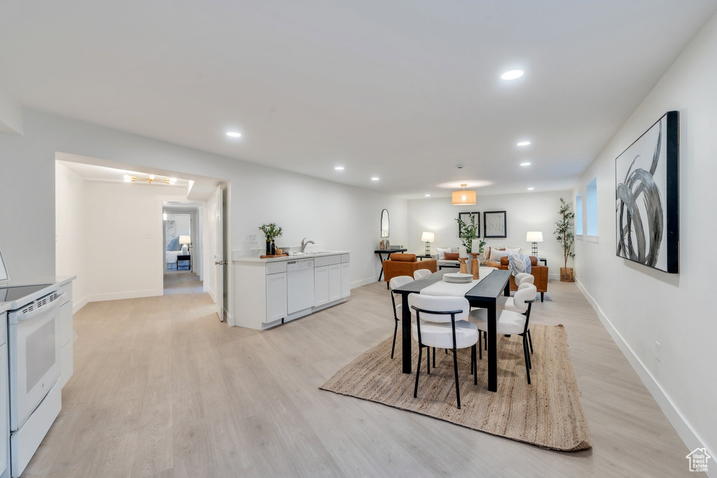 Dining area with light wood-type flooring, baseboards, and recessed lighting