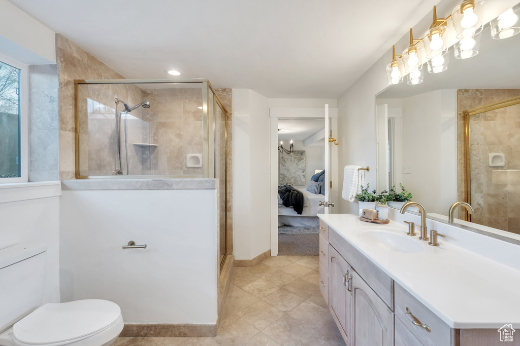 Bathroom with toilet, vanity, connected bathroom, and a stall shower