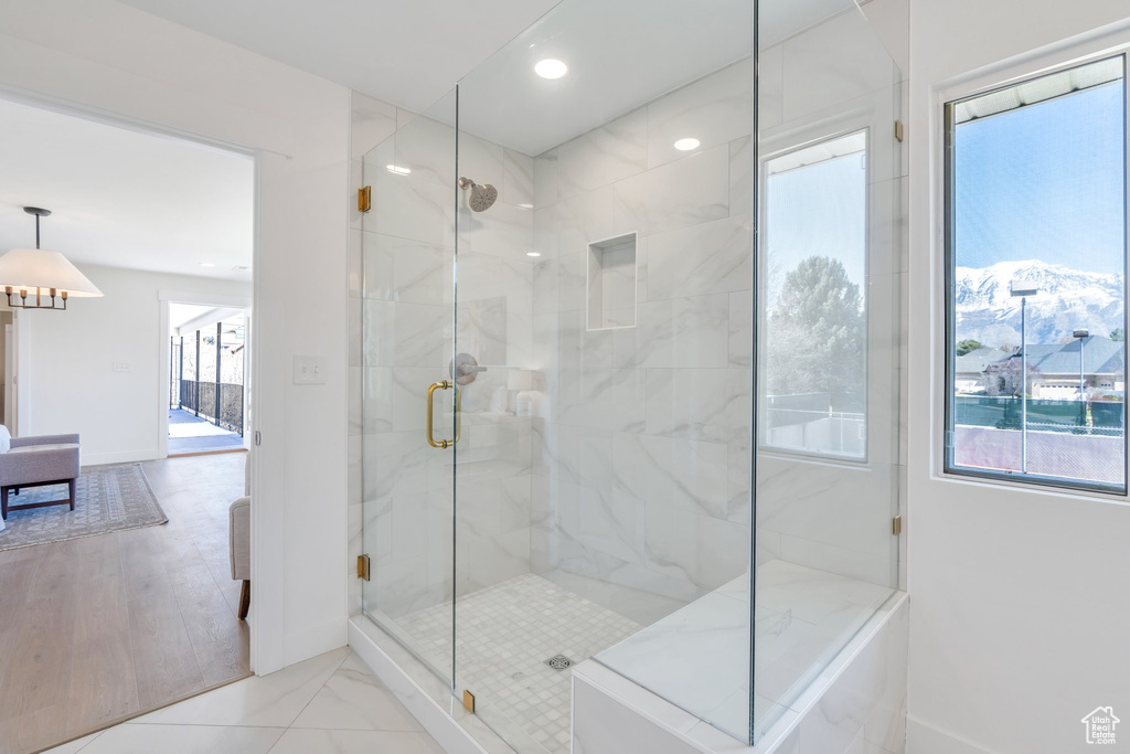 Ensuite bathroom featuring baseboards, ensuite bathroom, a stall shower, and recessed lighting