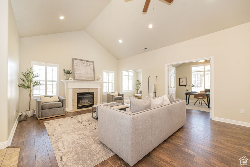 Living room featuring a healthy amount of sunlight, a tile fireplace, and wood-type flooring