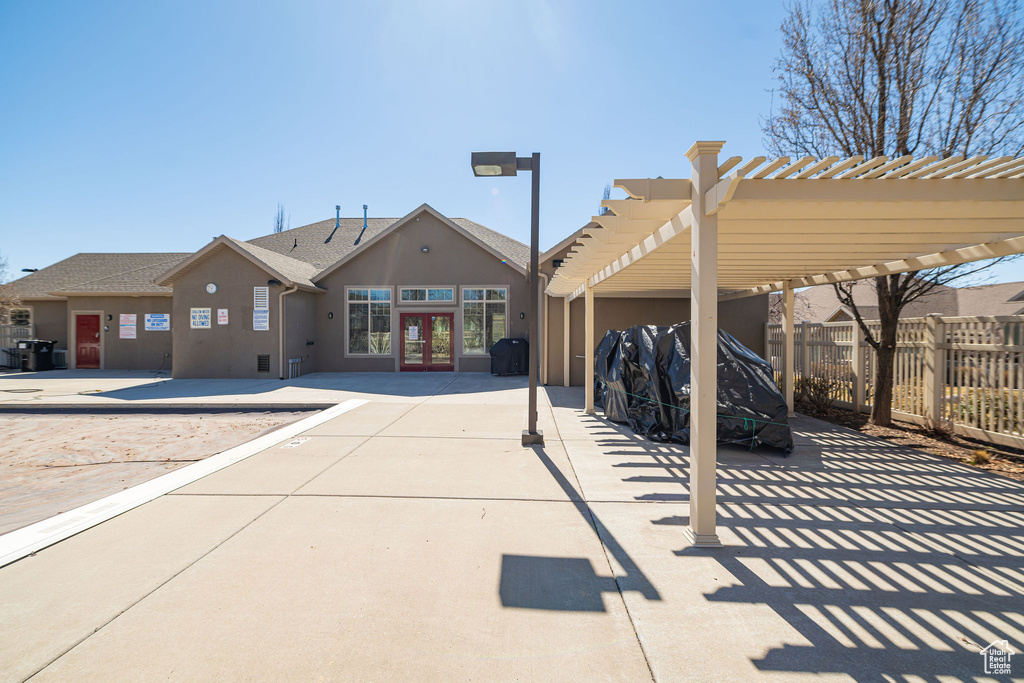 Exterior space with french doors, a pergola, fence, and a grill