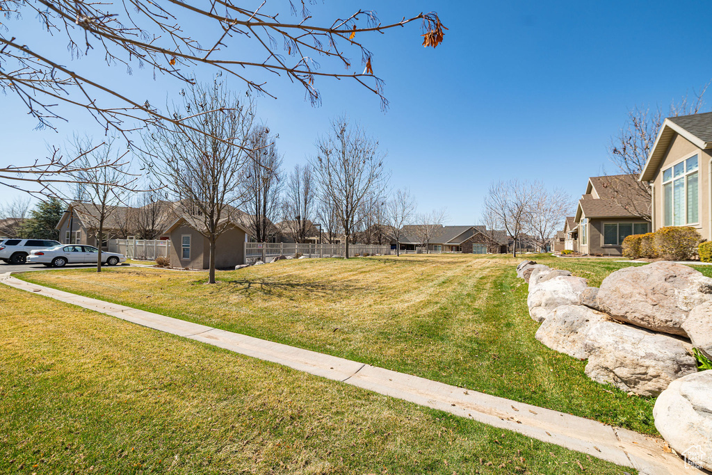 View of yard with a residential view and fence
