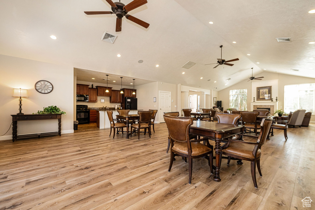 Dining space with visible vents, light wood-style floors, and ceiling fan