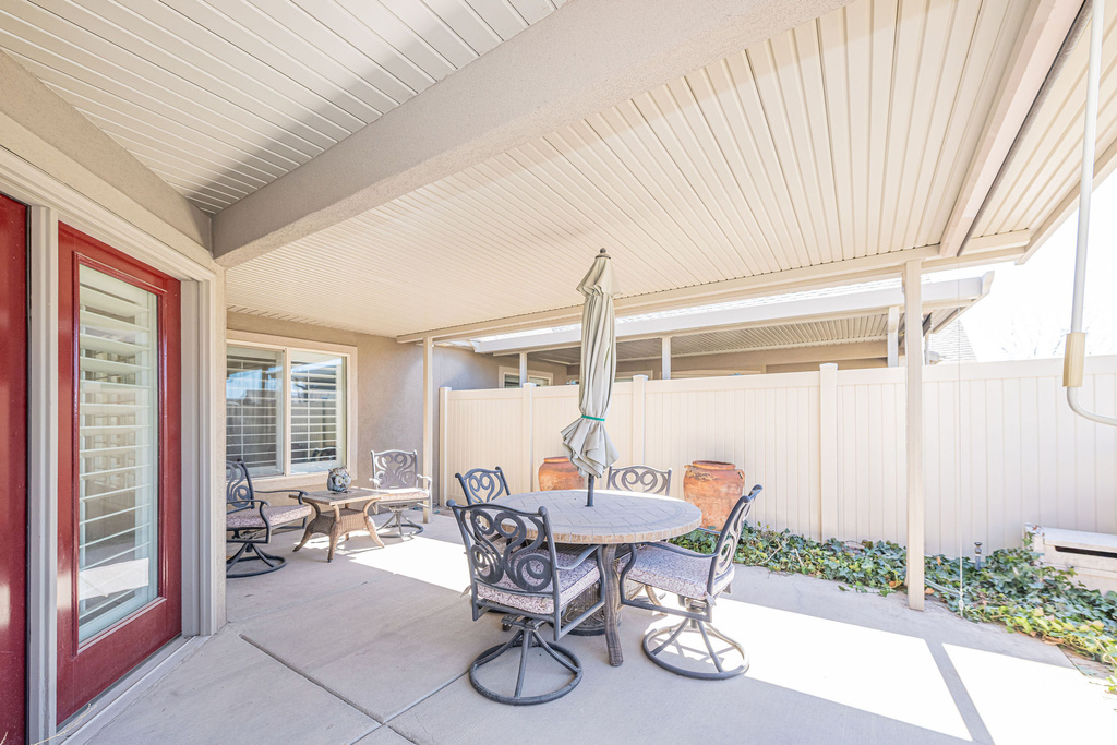 View of patio with fence and outdoor dining area