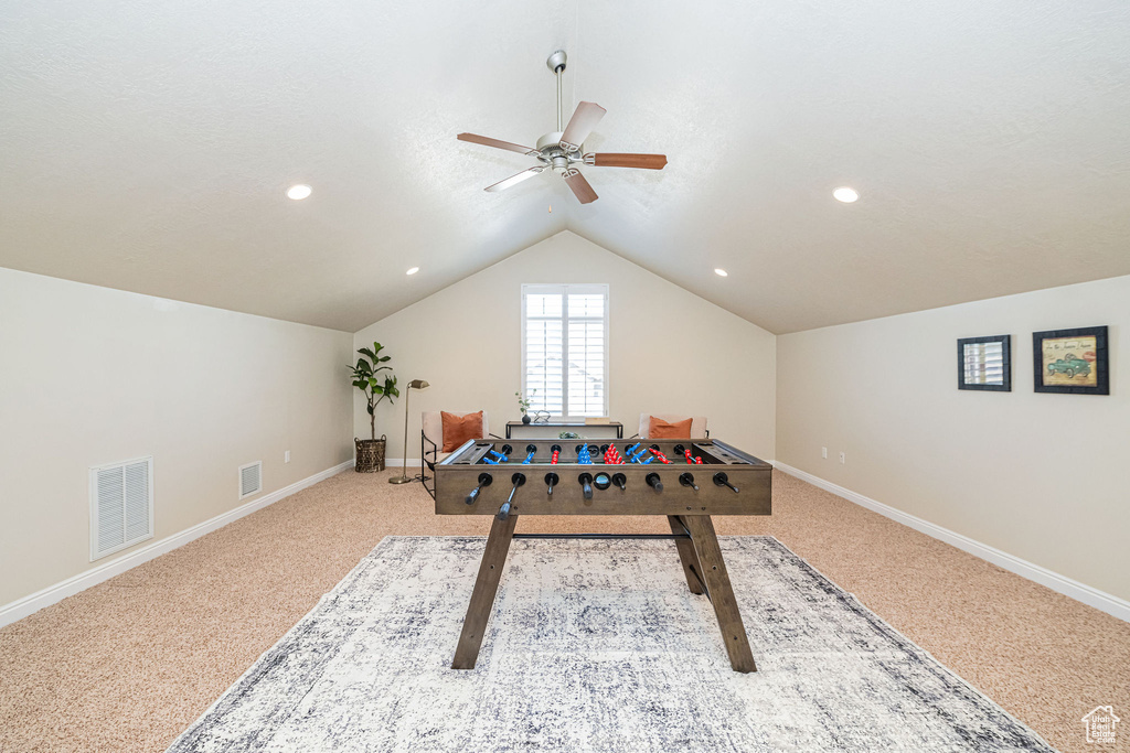Playroom featuring baseboards, visible vents, lofted ceiling, and ceiling fan