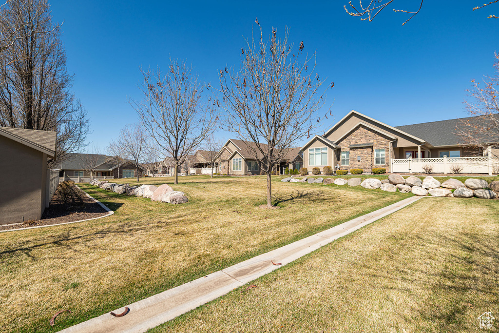 View of yard with a residential view and fence