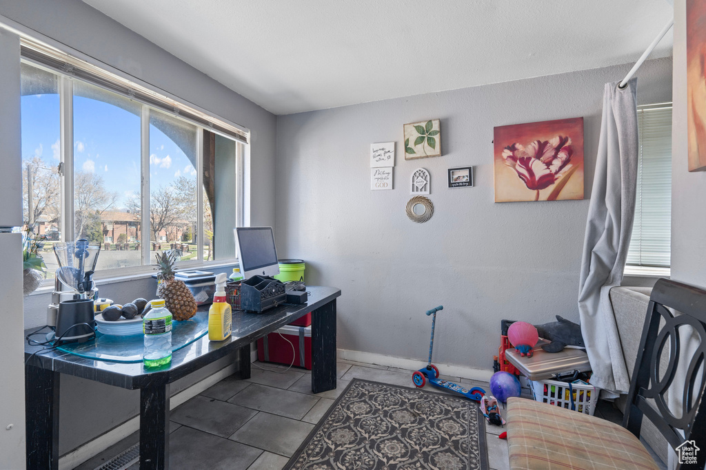 Tiled office featuring baseboards
