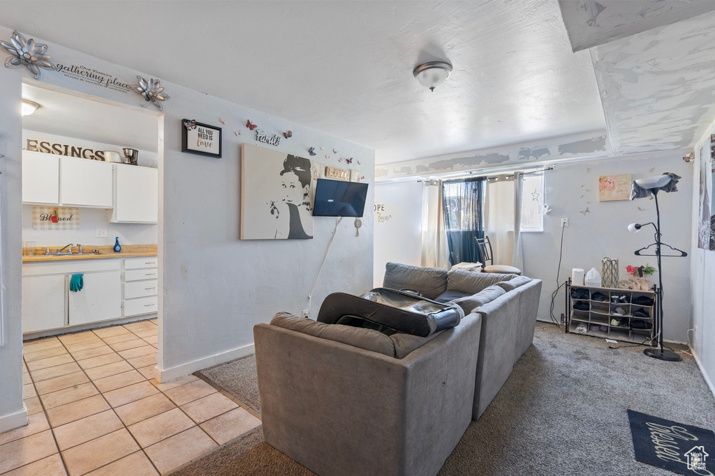Living room with baseboards and light tile patterned floors