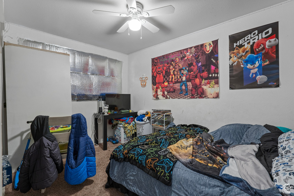 Bedroom featuring a ceiling fan and carpet floors
