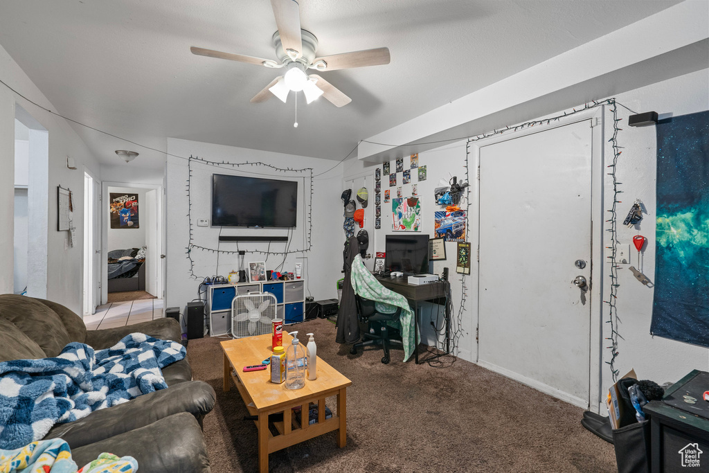 Living area featuring carpet floors and ceiling fan